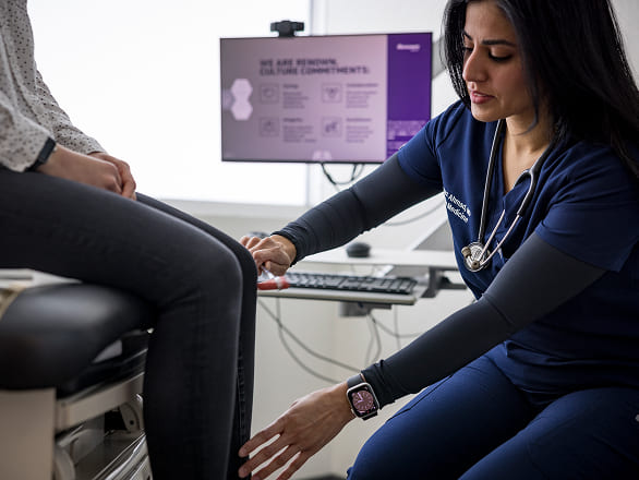 A family medicine doctor inspects a patient's knee