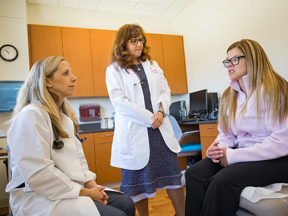 Two OB/GYN doctors talk with a patient