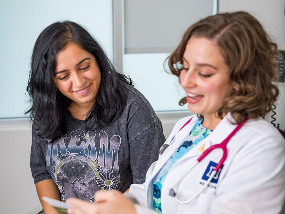 A doctor at the Student Outreach Clinic talks with a patient