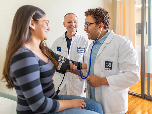 Resident and doctor examining a patient