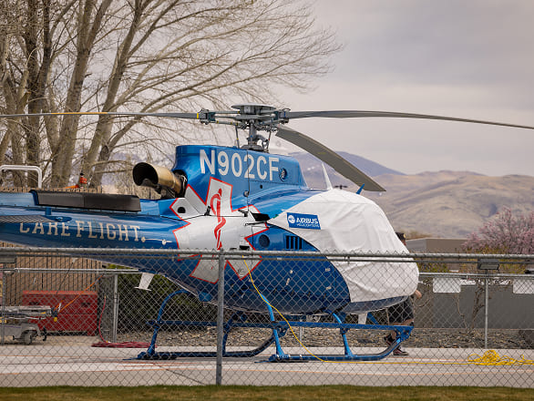 A helicopter sits ready on a hospital helipad