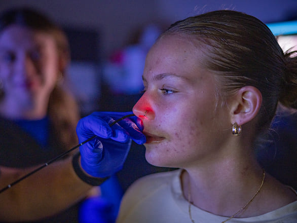 A patient gets a test administered in her nose