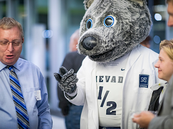 Alphie the unr mascot talking with researchers