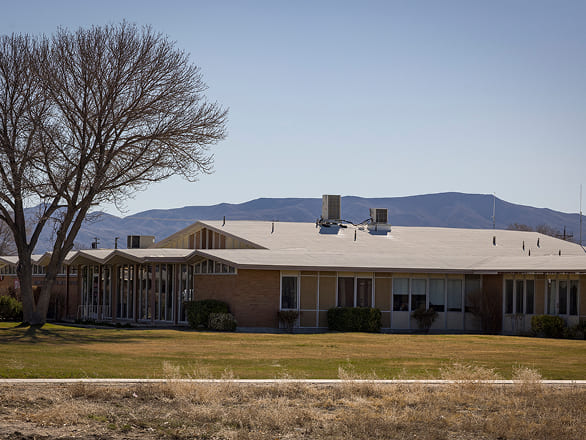 Rural outreach clinic building with mountains in the background.