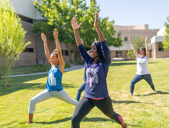 Students doing yoga outside