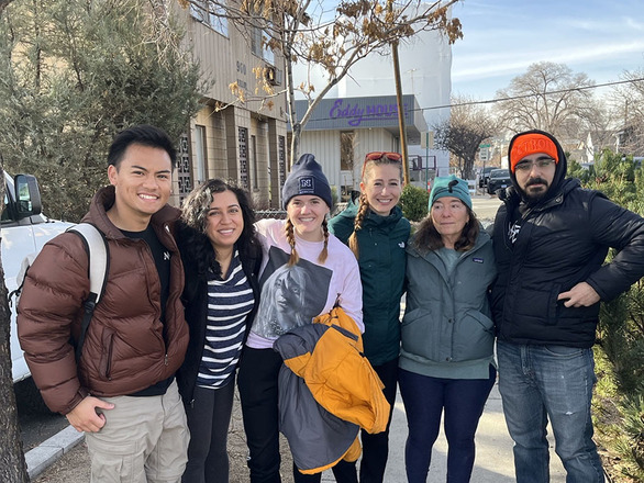 A group of student volunteers with the SOC pose for a group shot in front of the Eddy House