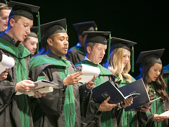 UNR Med students reciting their physician's oath during their hooding ceremony.