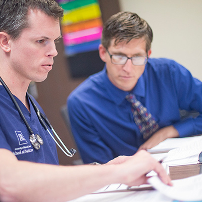 Med student and a mentor going over paperwork