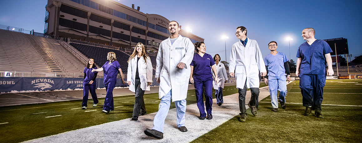 Med Students Walking on the football field