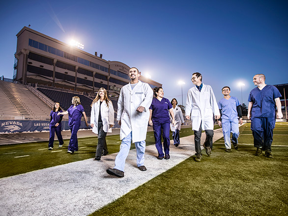Med students walking in Mackey Stadium