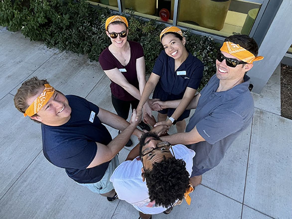 Medical students in colored bandanas doing an icebreaker challenge.