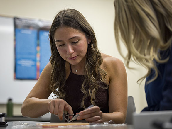 A student practicing stitching.