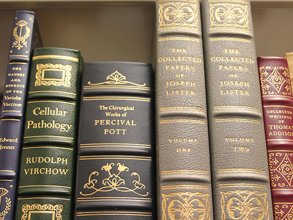 Historical book covers on a shelf.