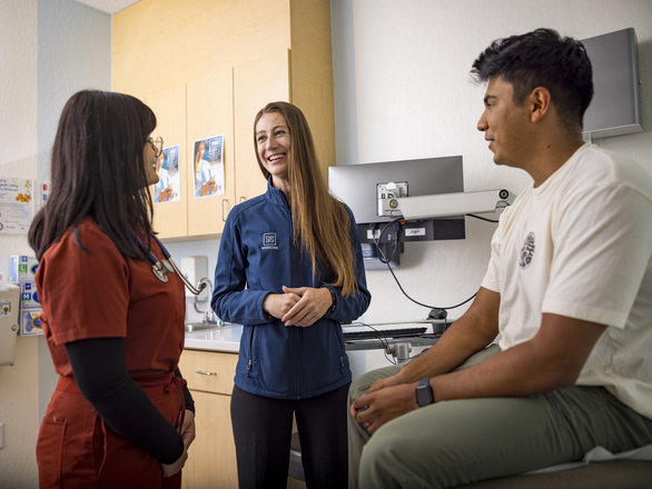 Nurses discussing among themselves with a patient in a clinical setting