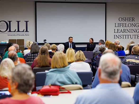 Sandovals speaking to a group of OLLI members