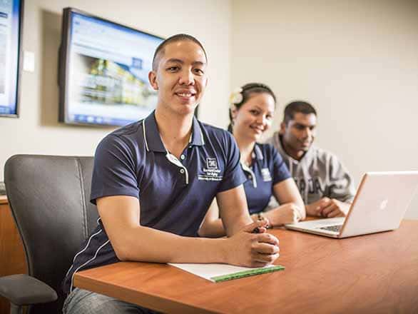 GAP students sitting at a table smiling at the camera