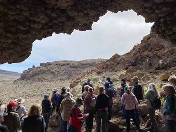 a group of older adults photographed inside a cave