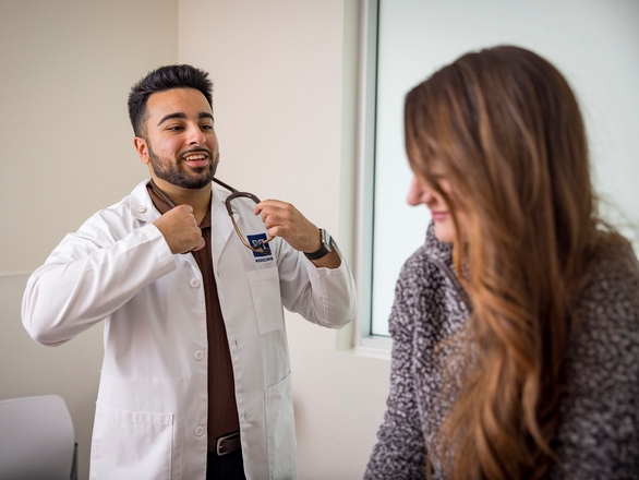 Medical student discussing with patient in a clinical setting
