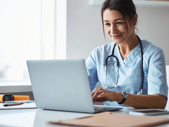 Graduate Medical Education student with computer