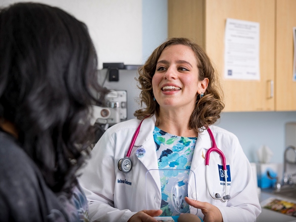 Medical student discussing with patient in a clinical setting