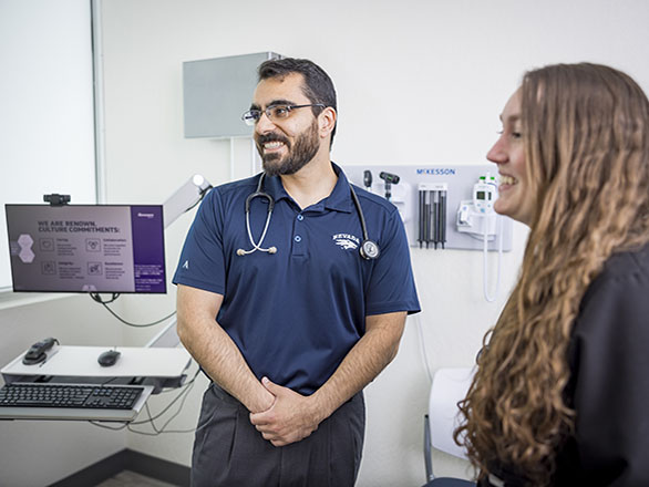 physician and resident with patient in clinical setting