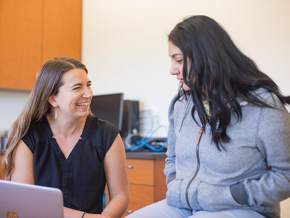 A resident talks with a patient at a women's health clinic