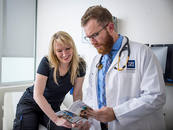 A doctor goes over a pamphlet with a patient