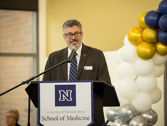 A faculty member giving a speech at a UNR Med event