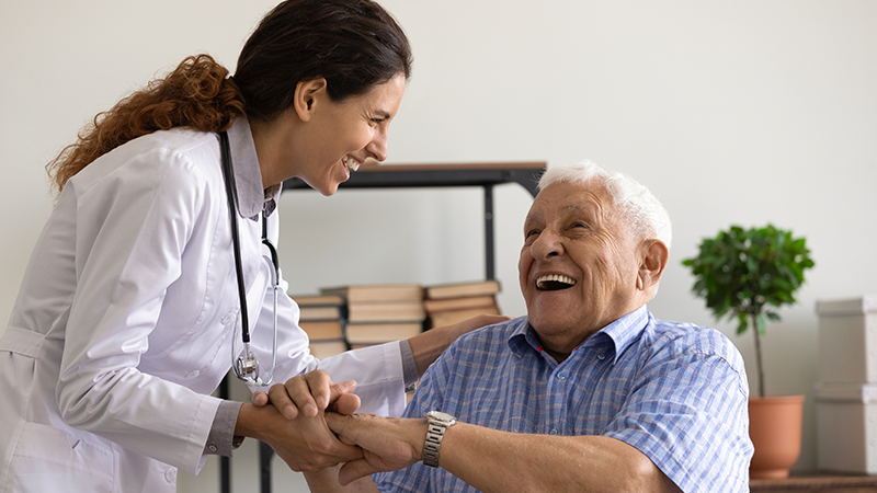 Geriatric medical professional with patient in clinical setting