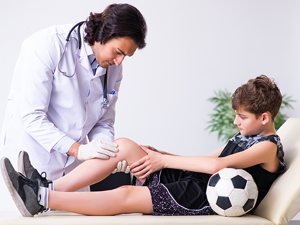 sports medical professional with patient in clinical setting