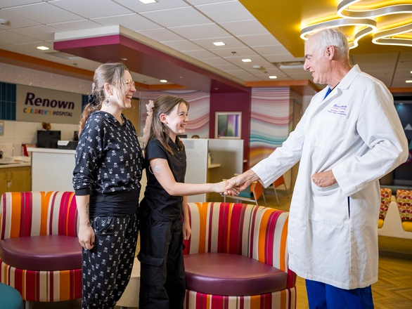 A doctor shaking hands with young patient in a hospital
