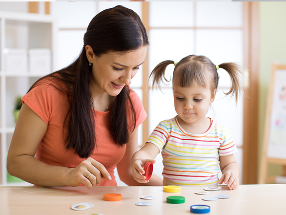 kid plays logical game at psychologist office