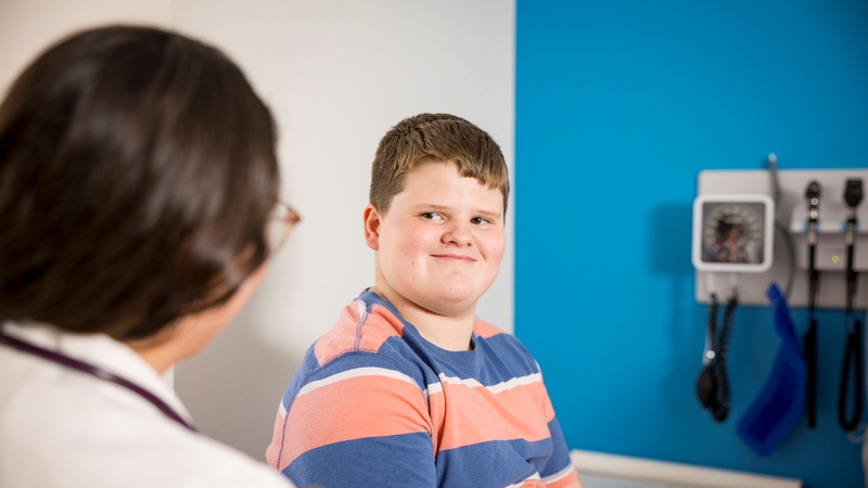 Medical student discussing with young patient in a clinical setting