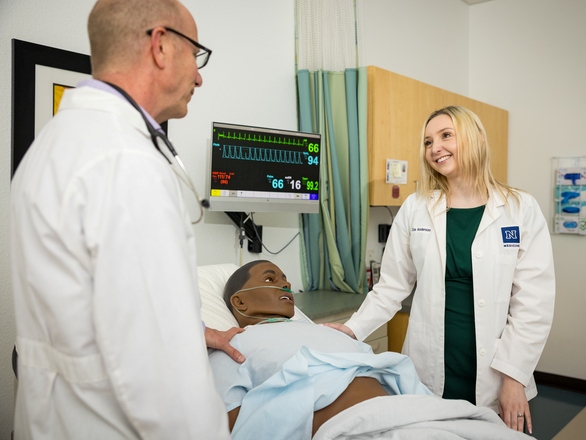 Medical instructor discussing with medical student in a clinical setting