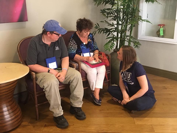 Aphasia patients at a clinic with a provider talking with them