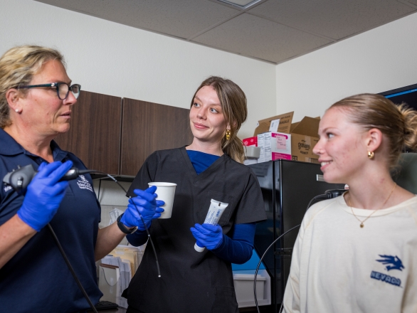 Pathologists in a medical setting discussing with a patient in a positive environment