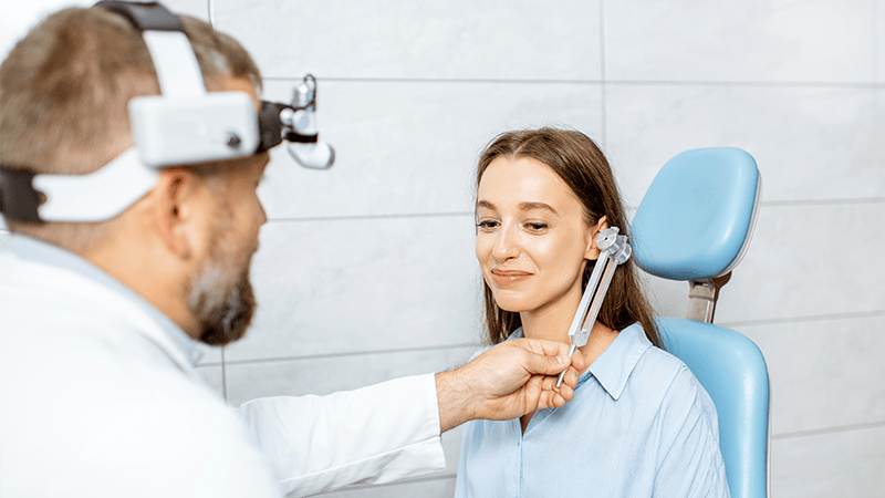 audiologist with patient in clinical setting