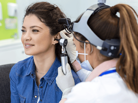 audiologist with a patient in clinical setting