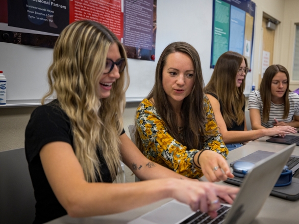 Speech pathology and audiology students studying with a laptop