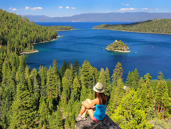 Someone sits above Emerald Bay admiring the view
