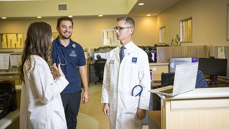 Physician Assistants talking with one another.