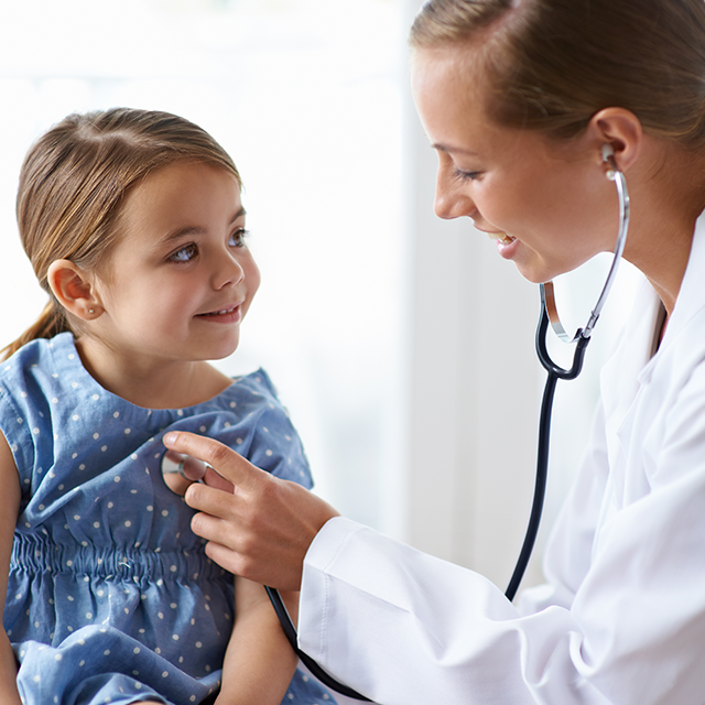 pediatric resident with patient in clinical setting