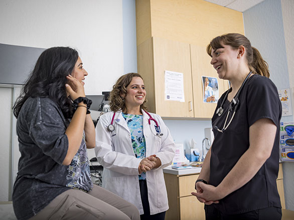 Medical students talking with one another in Student Outreach Clinic.