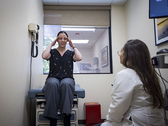 A patient in a clinic talking with a physician.