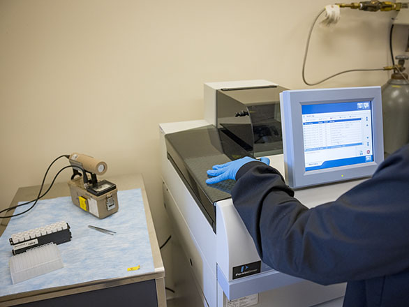 A person in gloves working with equipment.