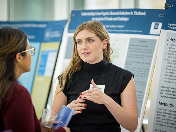 A student presenting a research poster.