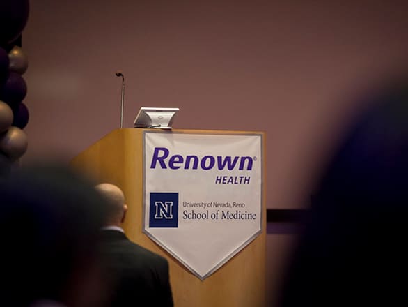 An empty podium with branding for UNR Med and Renown