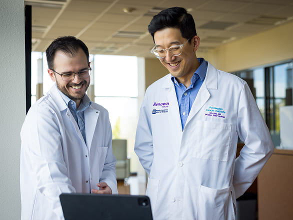 Researchers looking at results on a computer together