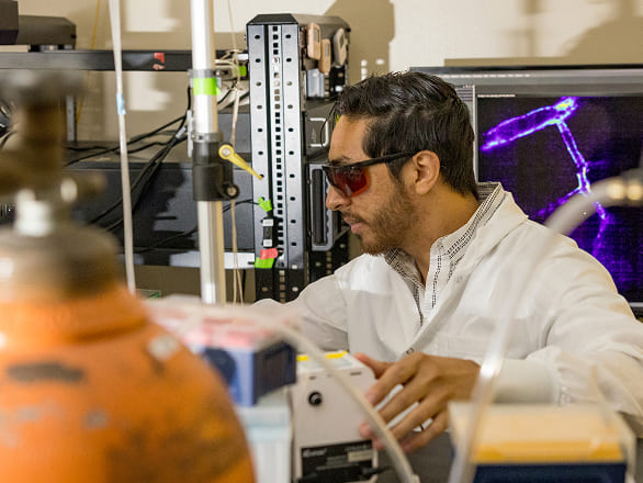 A biomedical research works in a lab with cool equipment